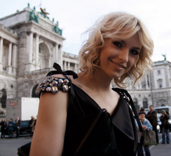 Lena Gercke in einem schwarzen Kleid mit großen Pailletten auf den Schultern