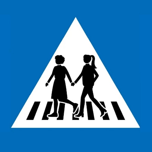 Ein Straßenschild mit 2 weiblichen Piktogrammen, die einen Zebrastreifen überqueren.