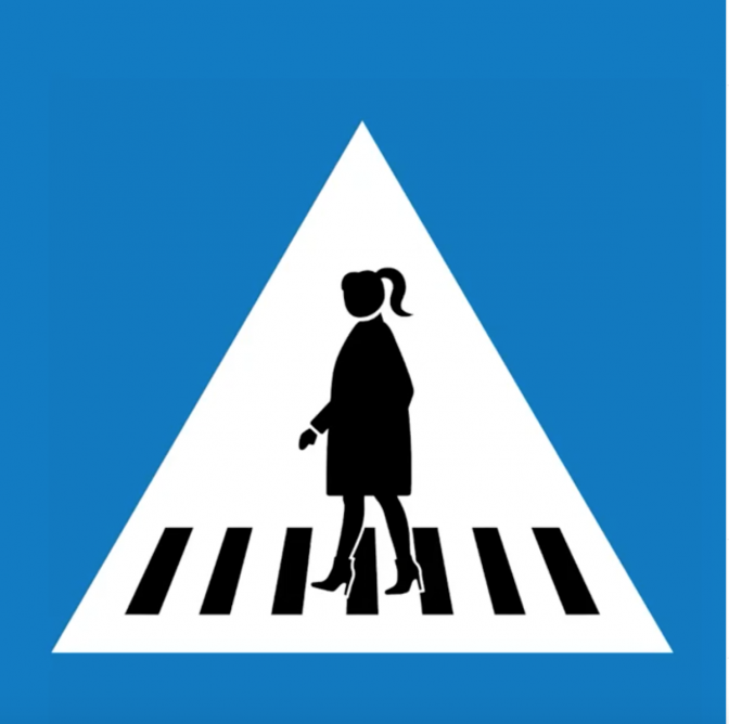 Ein Straßenschild mit einem weiblichen Piktogramm, das einen Zebrastreifen überquert. Die Frau hat einen Pferdeschwanz und trägt Pumps.