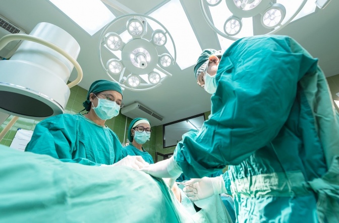 Ärzte und Ärztinnen in steriler Schutzkleidung bei einer Operation