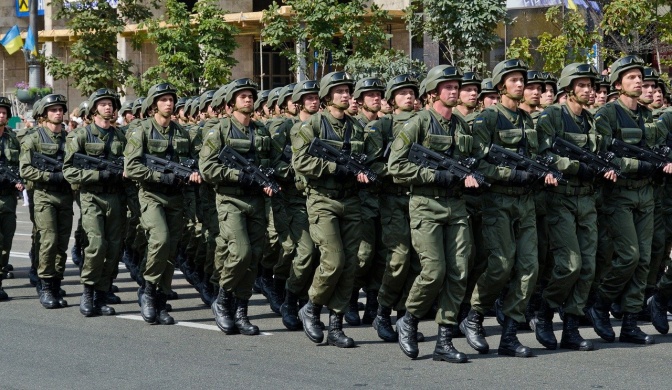 Marschierende Soldaten in Uniform und mit Helmen