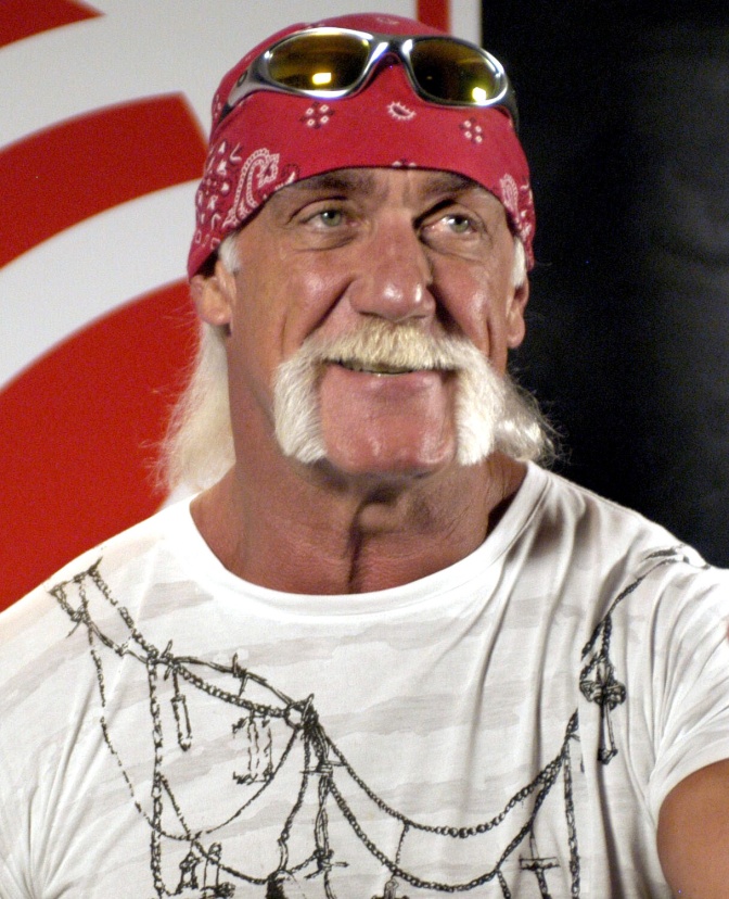 Hulk Hogan mit weißem Schnurrbart und einem roten Banana. Er schaut seitlich an der Kamera vorbei.